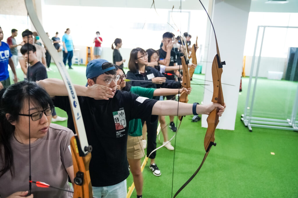 SIT Alumni put their game faces on and focus for the perfect shot.