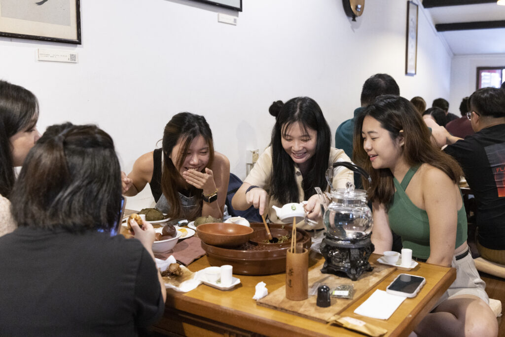 Participants try their hand at brewing some aromatic tea